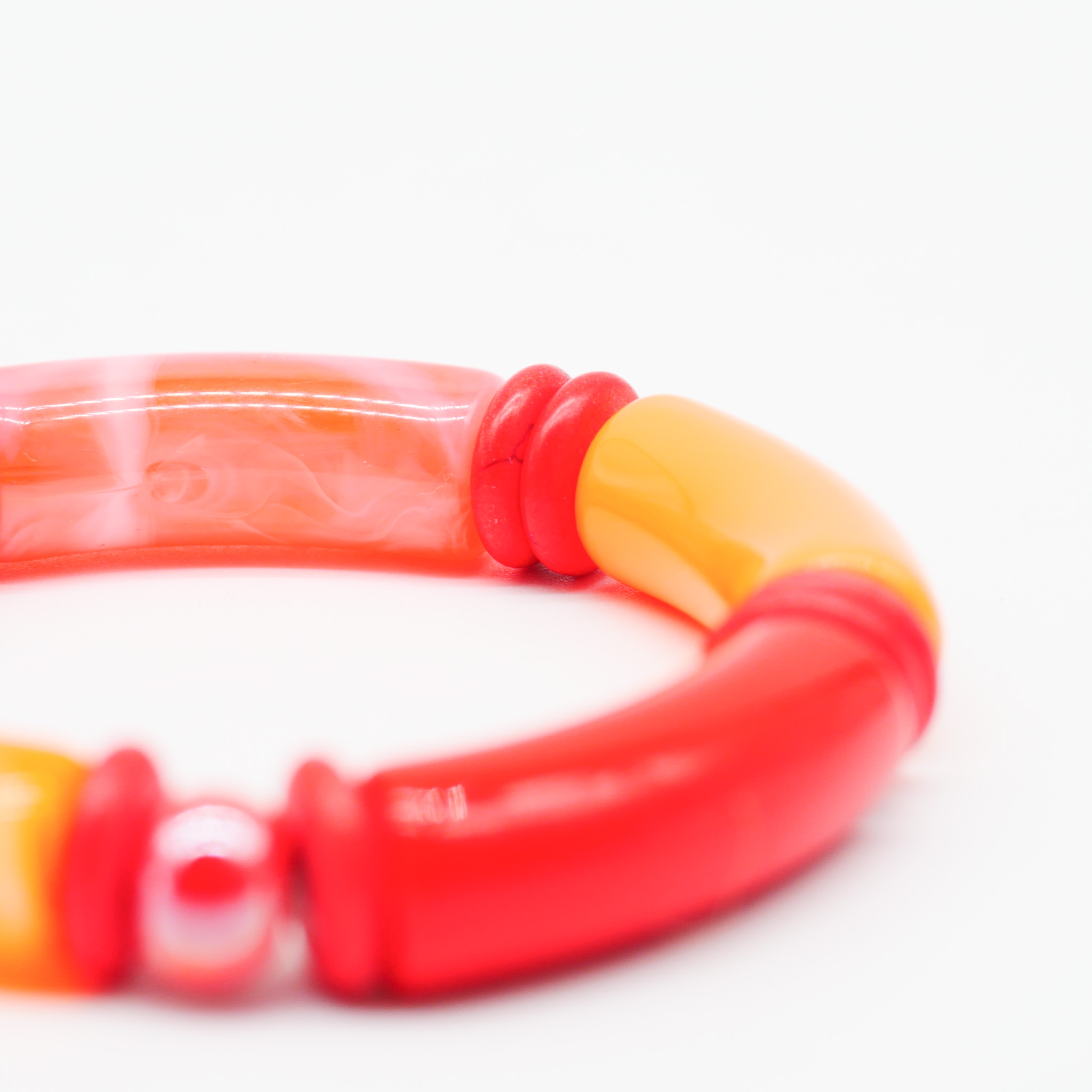Bracelet "tube" on elastic string, curved plastic pearls + howite, orange
