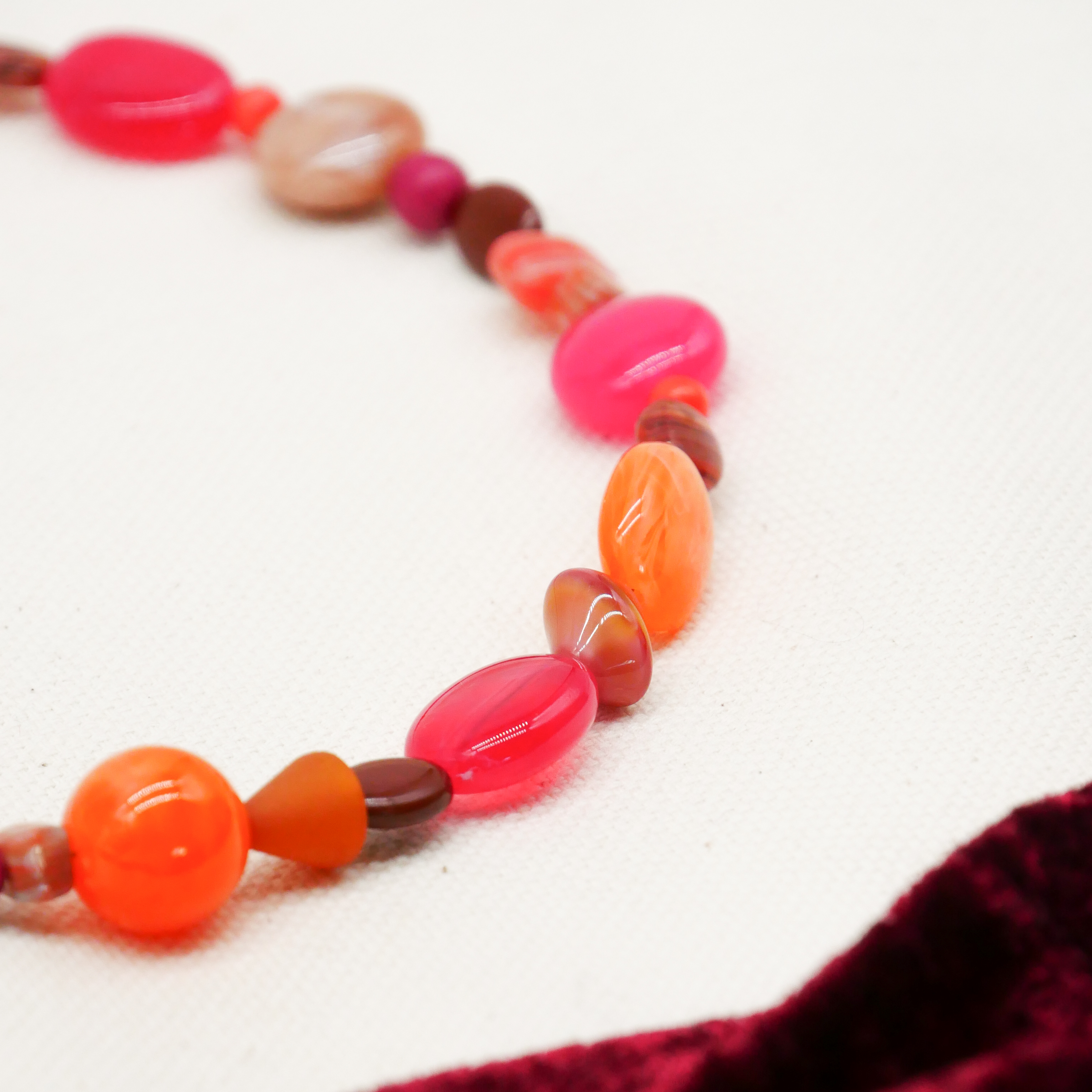 "Summer Feeling",  Chain with different shapes, Glas- and Resin Pearls, pink-orange