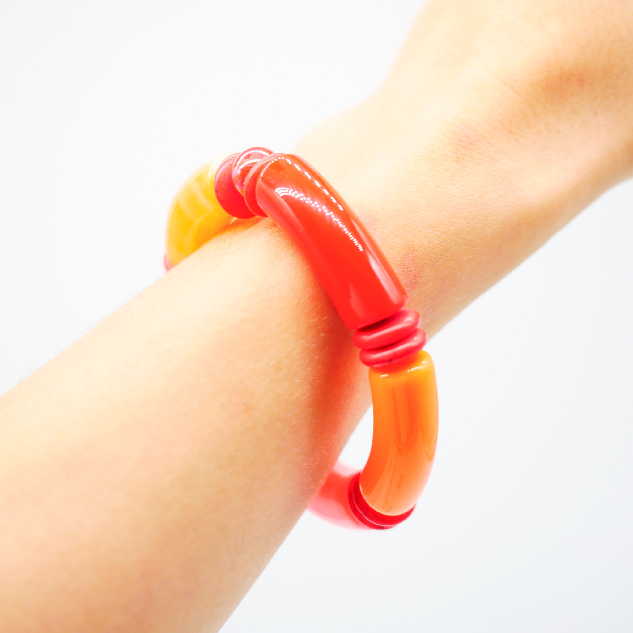 Bracelet "tube" on elastic string, curved plastic pearls + howite, orange