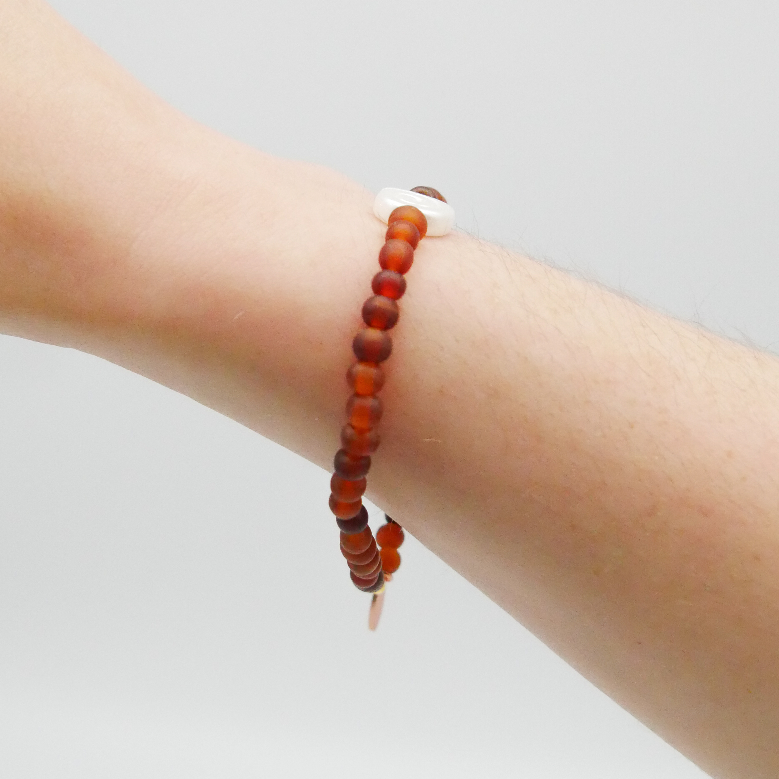  "Shell" Armband auf Gummi dunkelbraune Carabo Hornperlen  ca. 5 mm, weiße Glasschnecke 