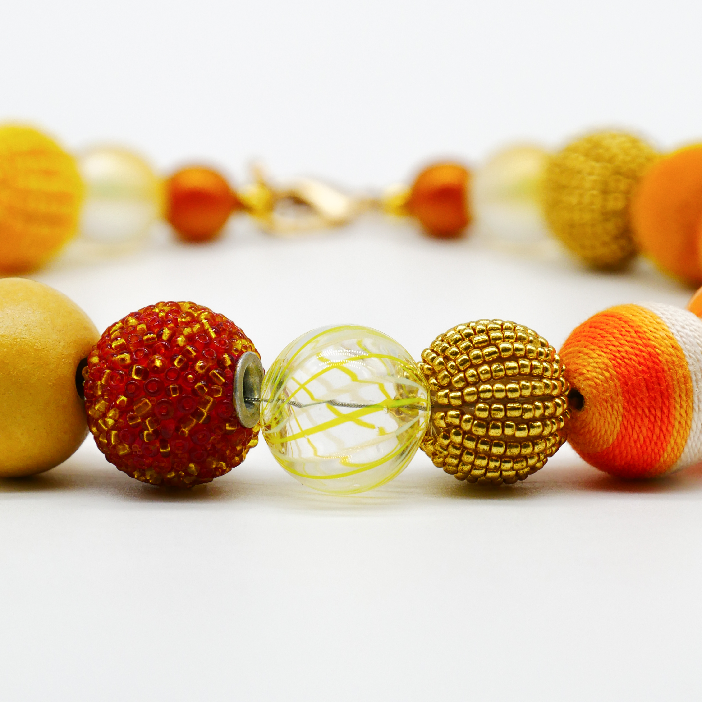 "Bollywood" Kette Ø ca. 20 mm, gelb-orange